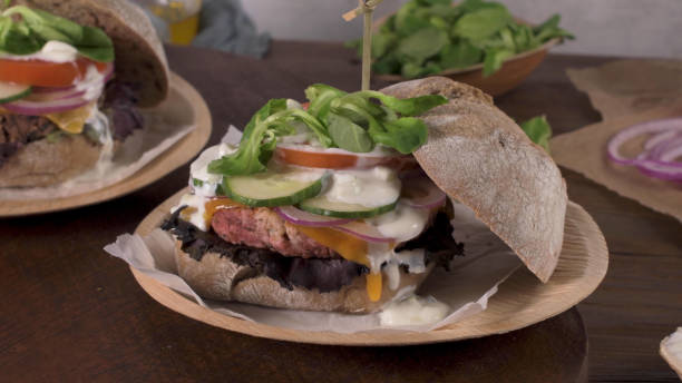 istock Healthy vegan burger with fresh vegetables and yogurt sauce 1579110711