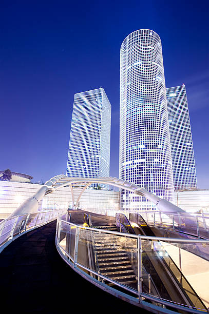 Azrieli centre in Tel Aviv Azrieli Center is a complex of skyscrapers in Tel Aviv. At the base of the center lies a large shopping mall. The center was originally designed by Israeli-American architect Eli Attia.The Azrieli Center is located on a 34,500 square meter site in Tel Aviv, Israel which was previously used as Tel Aviv's dumpster-truck parking garage. The Azrieli Center Circular Tower, is the tallest of the three towers, measuring 187 m (614 ft) in height. Construction of this tower began in 1996 and was completed in 1999. The tower has 49 floors, making it the tallest building in Tel Aviv and the second tallest in Israel tel aviv photos stock pictures, royalty-free photos & images