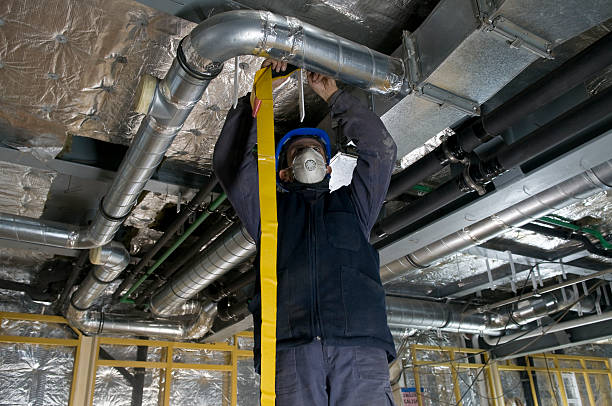 istock Worker Wrapping an HVAC Air Duct with Foil Tape 157913850