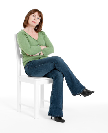 Dining chair with light wood legs and solid leather seat and light green top. The image is isolated on a white background.