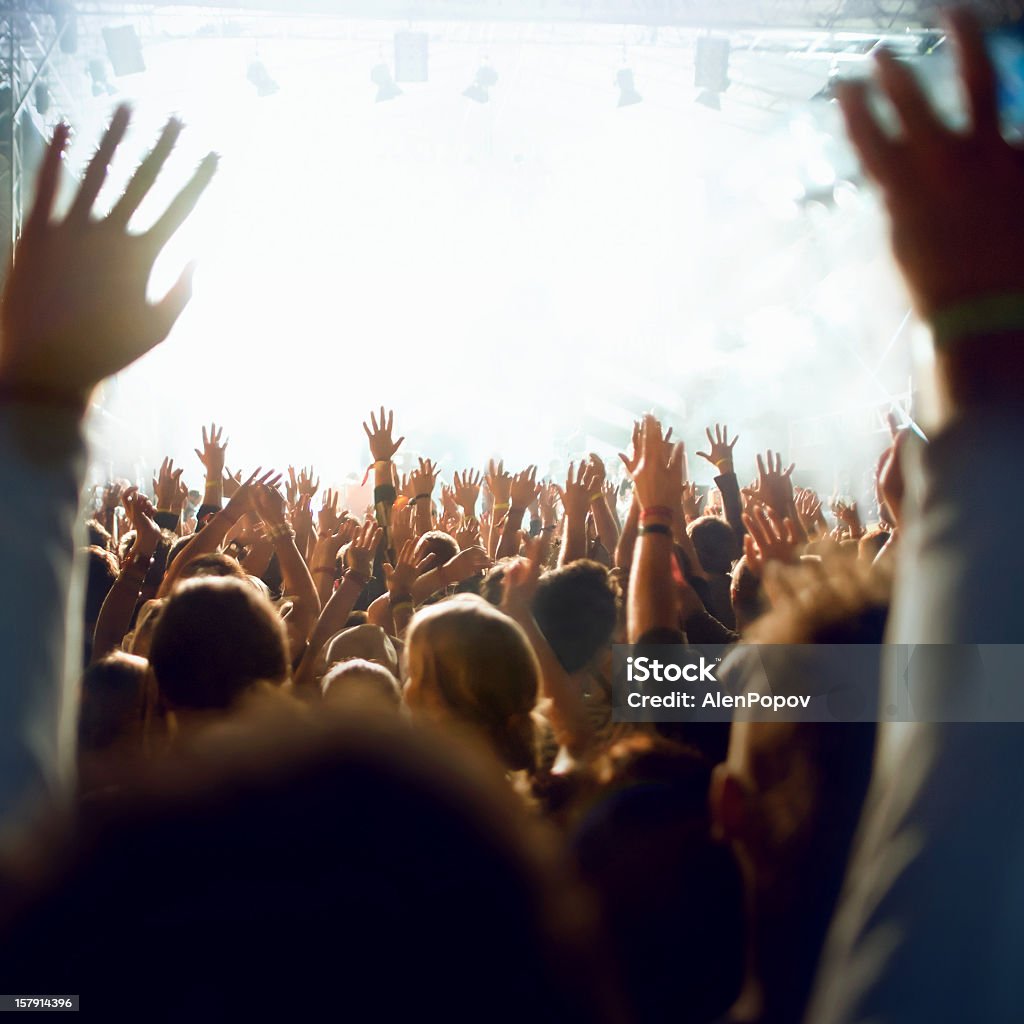Concert crowd Crowd cheering and watching a band on stage. Dancing Stock Photo