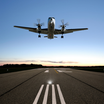 twin propeller airplane landing on runway at twilight, square frame (XXL)