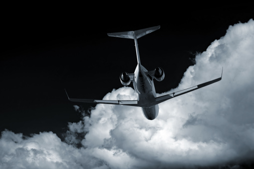 corporate jet airplane flying at night with storm clouds (XL)