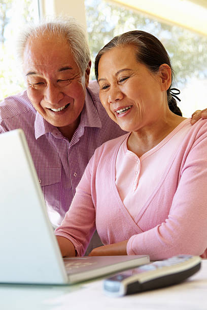 istock Senior Taiwanese couple working on laptop 157914982