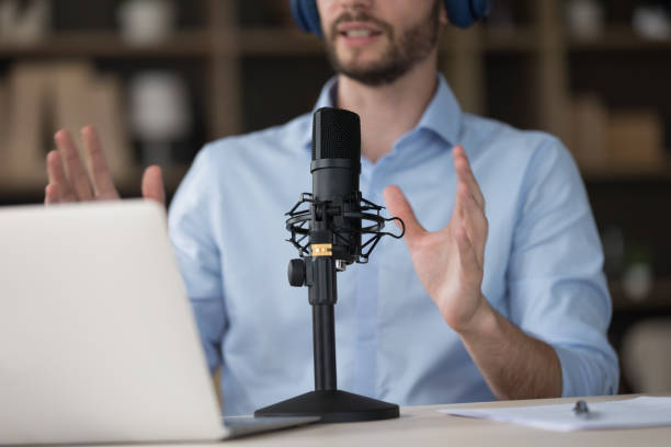 istock Young Internet radio host in wireless headphones broadcasting on air 1579174000