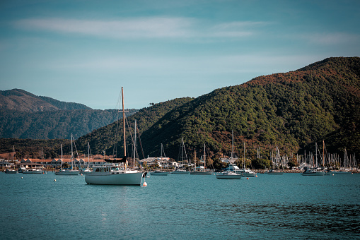 An image of a boat moored in a harbor. The image was taken in morning light and is very colorful