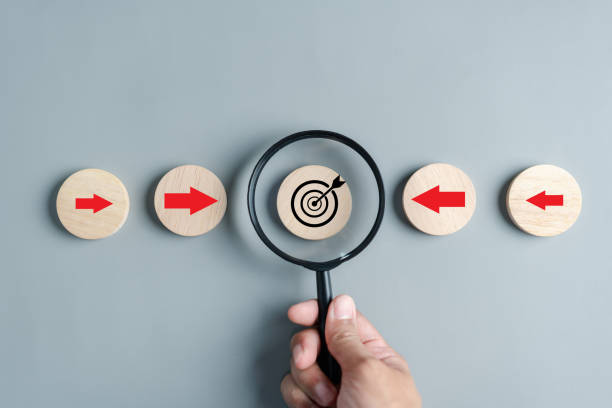 istock Magnifier glass focus to target objective with business icons. planning development leadership and customer target group concept. 1579301969