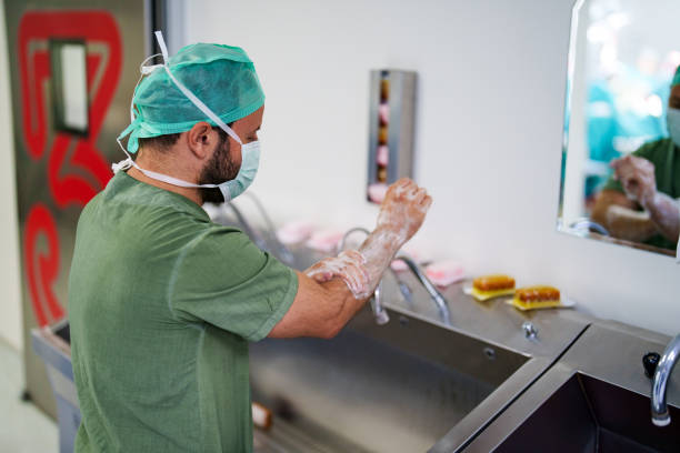 istock Surgeon Wearing Scrubs Washing Hands Before Operation 1579350923