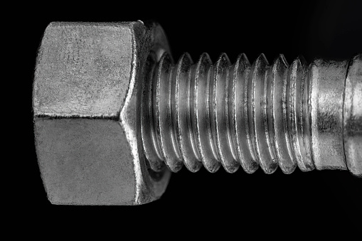 Bolt and nut close up on a black background