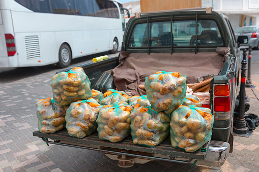 Bags of potato for selling on the back of the car