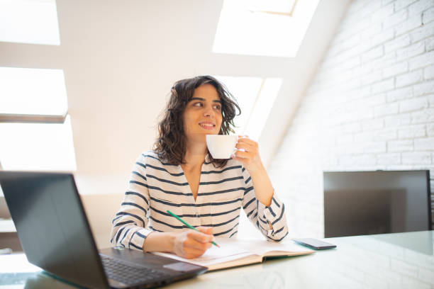 istock Young woman attending online class from home 1579445837