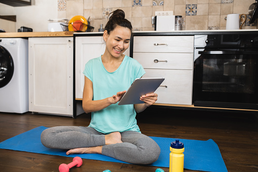 Mid adult woman exercising exercising at home