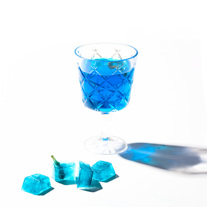 Glass with Butterfly tea and blue tea with ices cubes on white isolated backgroud,refresh herbal drink