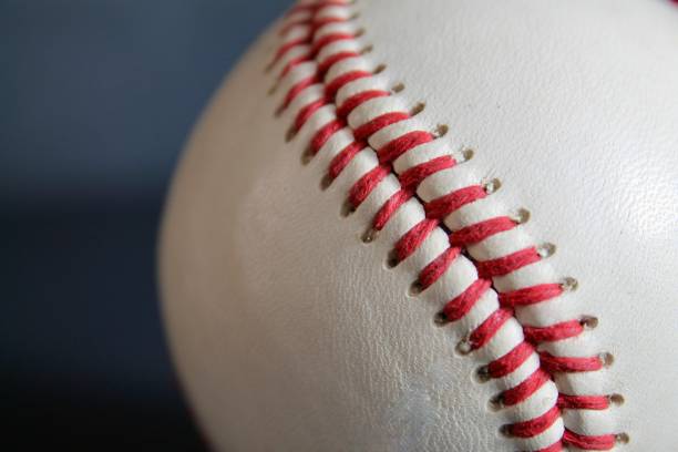 istock leather baseball with red stitches isolated 1579454279