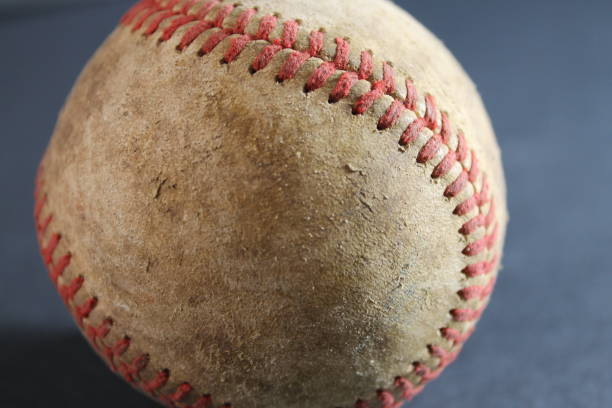 istock leather baseball with red stitches isolated 1579454283
