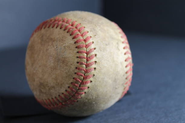 istock leather baseball with red stitches isolated 1579454284