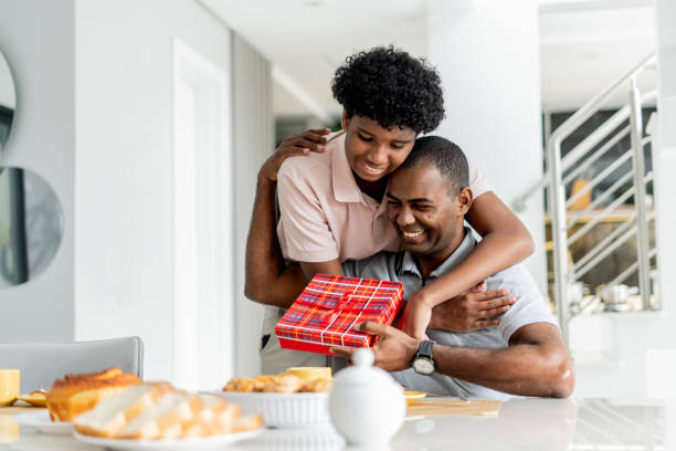 istock Son giving gift to father 1579468273