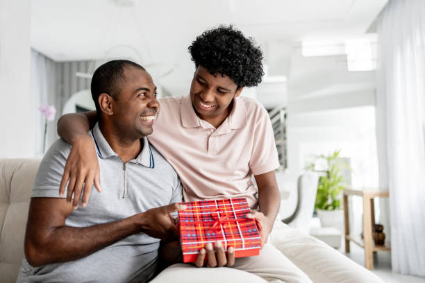 istock Son giving gift to father 1579468291