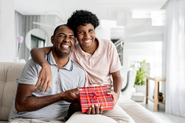 istock Son giving gift to father 1579468294