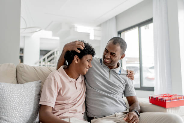 istock Son giving gift to father 1579468295