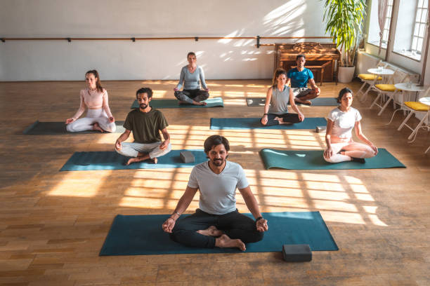 istock Male Indian Meditation Teacher With Student Group 1579472624