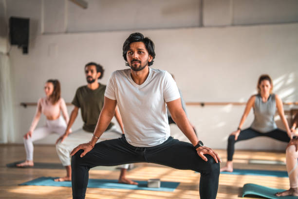istock Indian Male Pilates Teacher at Workout With Multiracial Group 1579472629