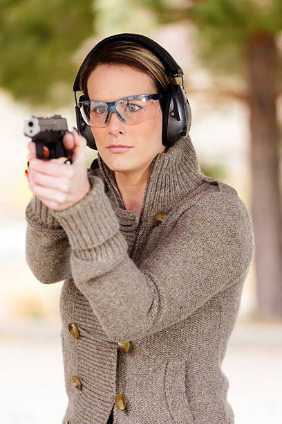istock Woman Pointing a Gun 157954803