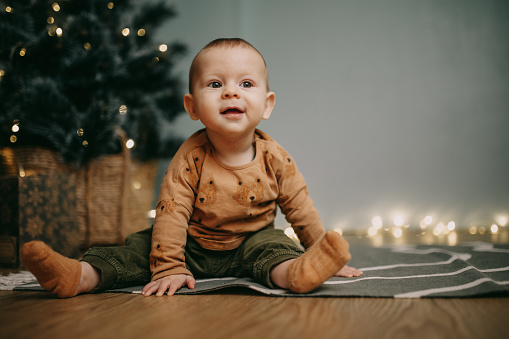 Happy baby boy excited for his first Christmas.