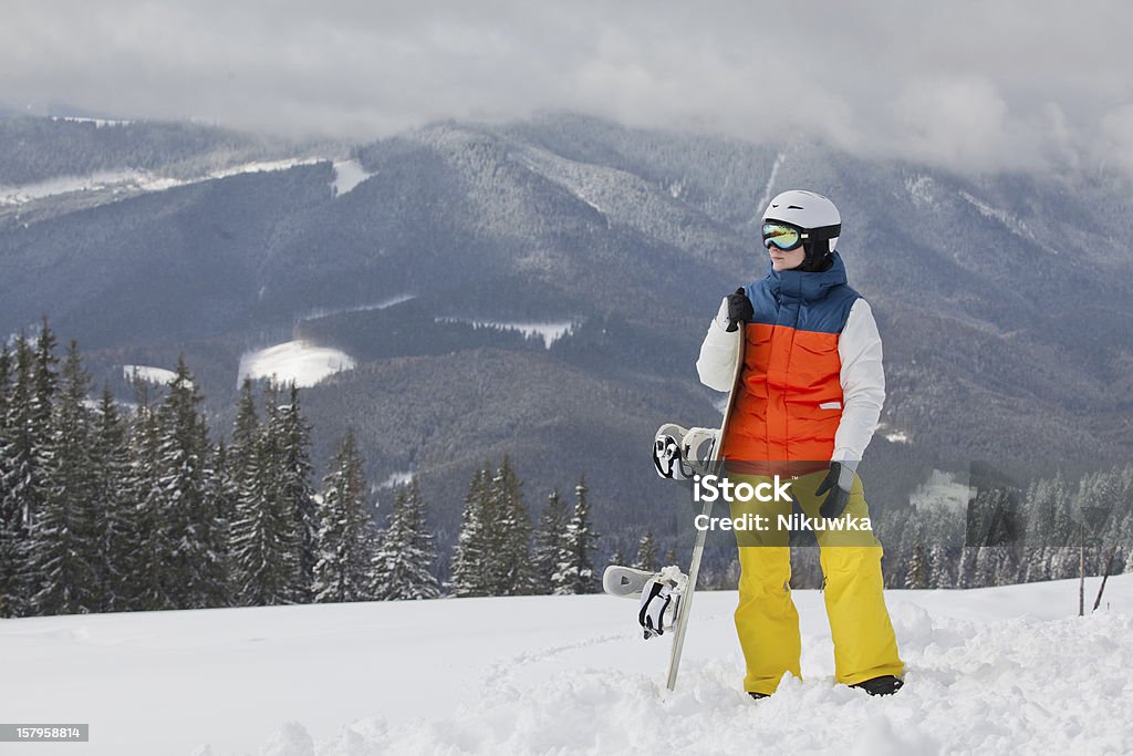 female snowboarder against sun and sky female snowboarder against sun and blue sky 18-19 Years Stock Photo
