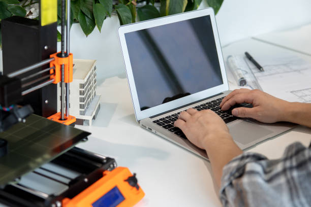 istock Man typing on laptop with blank screen working in creative lab. 1579615856