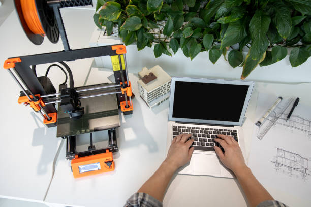 istock Man typing on laptop with blank screen working in creative lab. 1579615885