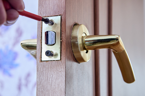 Push lever door handle with latch is assembled in recess of interior door.