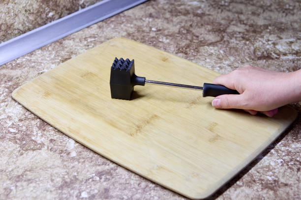 istock Meat tenderizer tool is meat pounder for strike steak or chicken breasts with meat mallet to loosen fibers and make meat softer and smoother. 1579647392