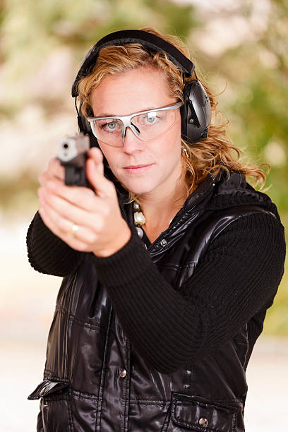 istock Woman Pointing a Gun 157971105