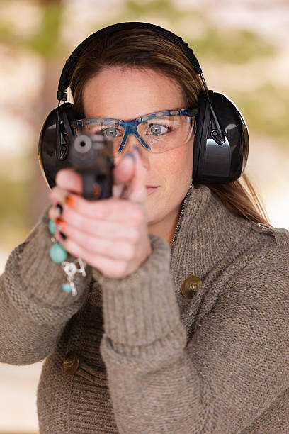 istock Woman Pointing a Gun 157971213