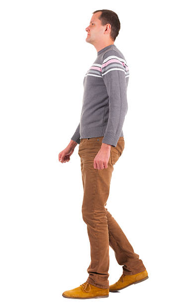 istock Back view of going   man in sweater and brown jeans. 157971659