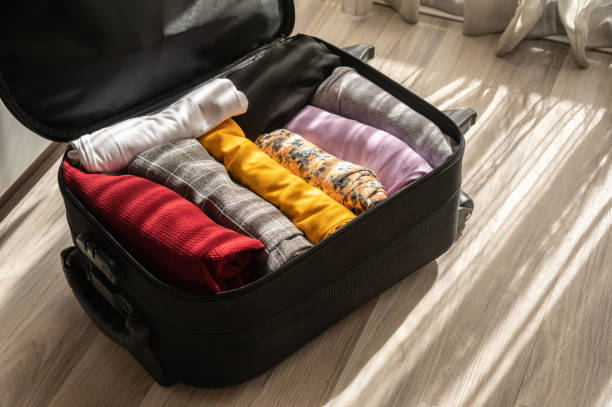 istock An opened suitcase with colorful clothings pack and arrange inside. 1579730287