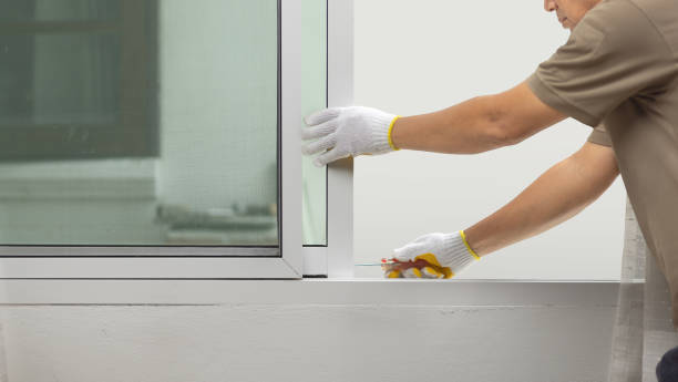istock Construction worker repairing the sliding window. 1579740303