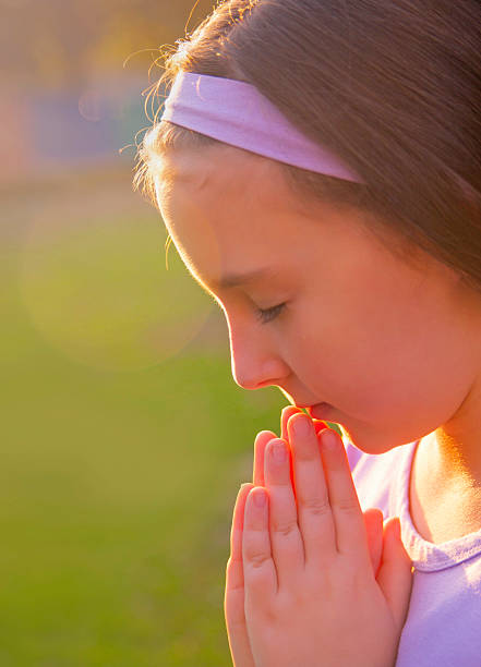 istock Little girl praying 157974351