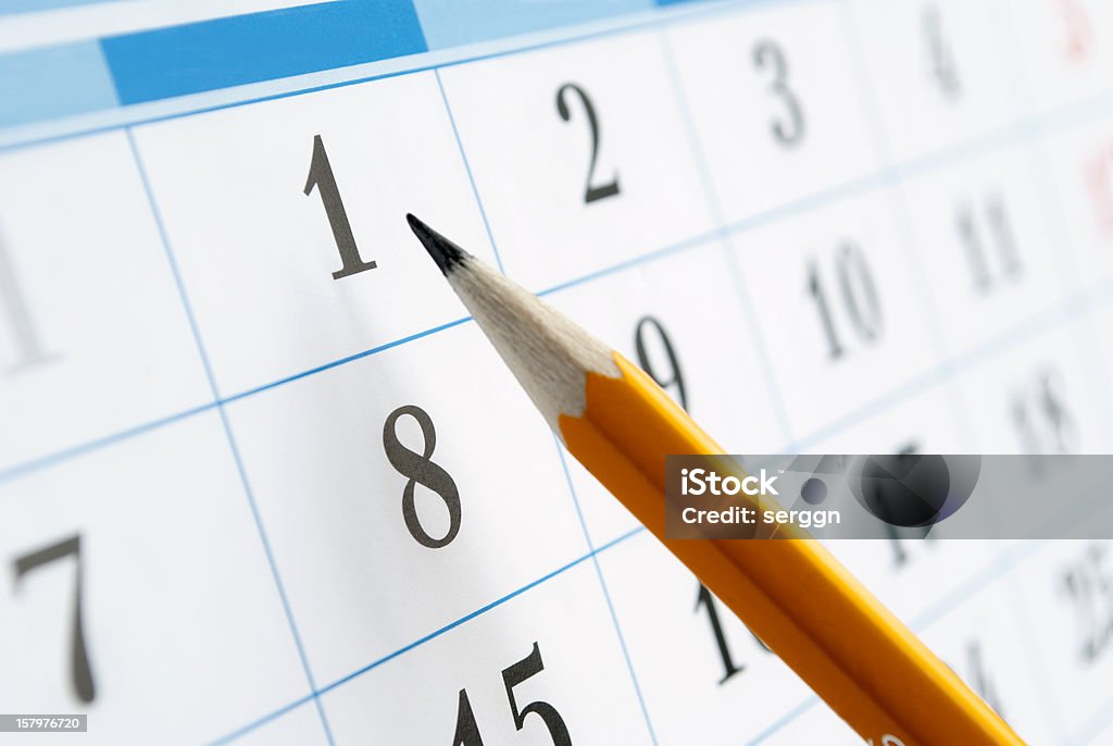 calendar page pencil points to a date in the calendar Calendar Stock Photo
