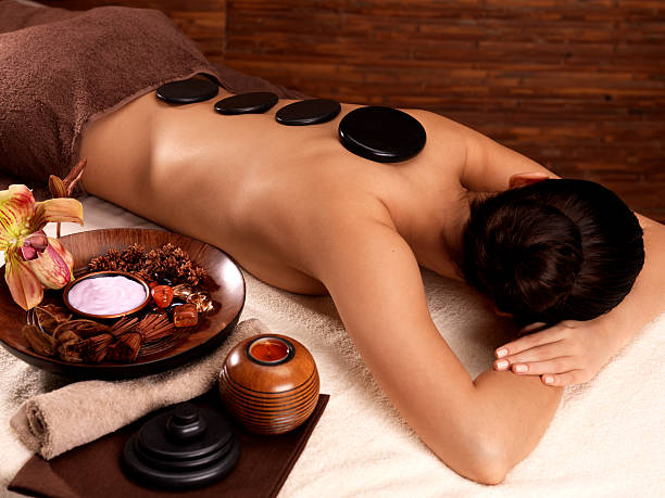 istock woman having stone massage in spa salon 157976741