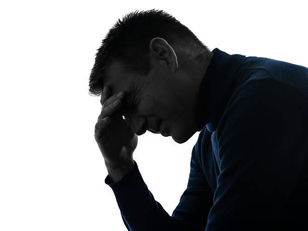 istock man headache pain  silhouette portrait 157977144