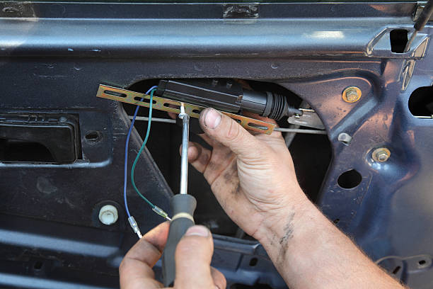 Car servicing Mechanic installing car central door lock motor car door photos stock pictures, royalty-free photos & images