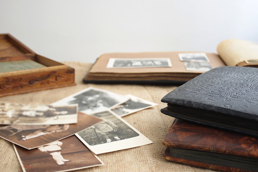 Old retro photo albums with vintage monochrome photographs in sepia color