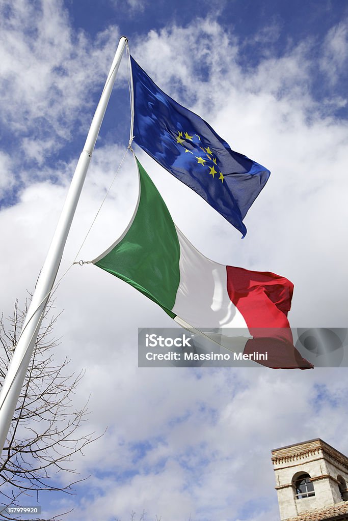 Italian And European Flags Italian and european flags against a beautiful sky Blue Stock Photo