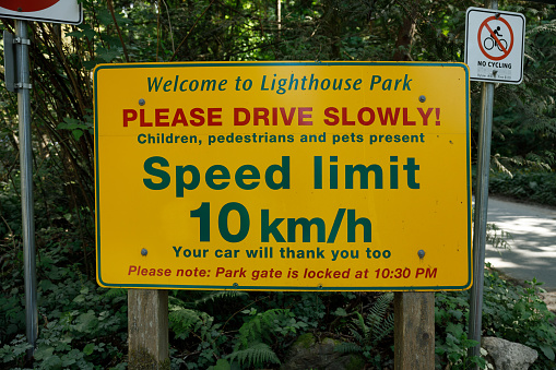 West Vancouver, Canada -May 20,2023: View of Warning sign Please drive slowly inside the Lighthouse Park in West Vancouver