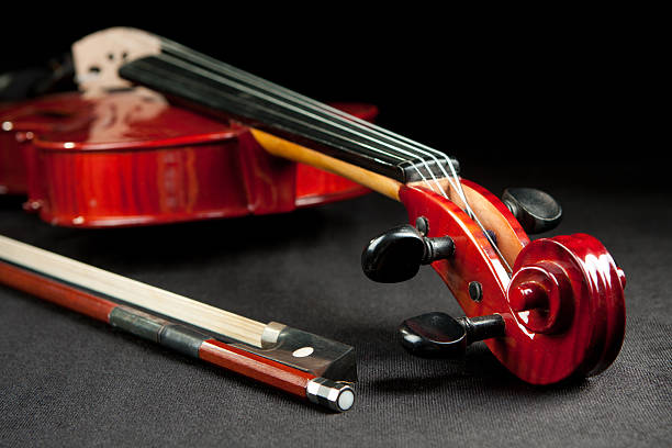 istock violing and bow on dark velvet background 157980808