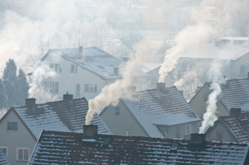 Smoking roofs of houses in a small town in winter; town Kamienna Gora; Lower Silesia; south-west Poland
