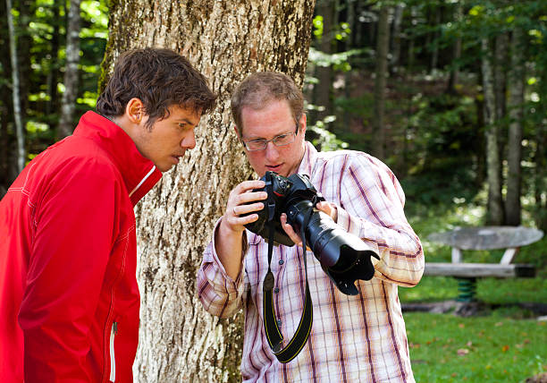 istock Two outdoor photographers inspecting result. 157982463