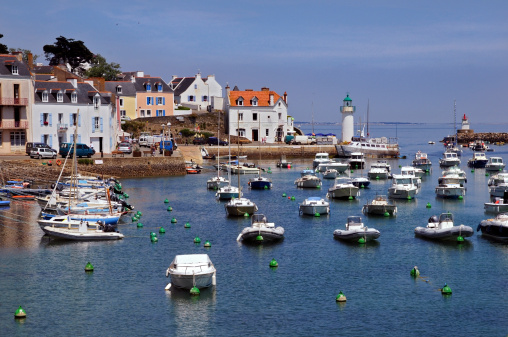 Port of Sauzon with the two lighthouses in the background on the island of Belle Ile in the Morbihan department in Brittany in north-western France. Typical buildings